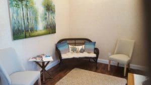 A living room with two chairs and a couch