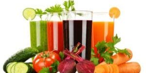 A group of glasses filled with different colored drinks.