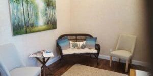 A living room with two chairs and a couch